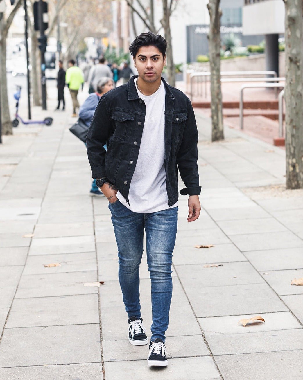 Man walking down street in Dark Blue jeans