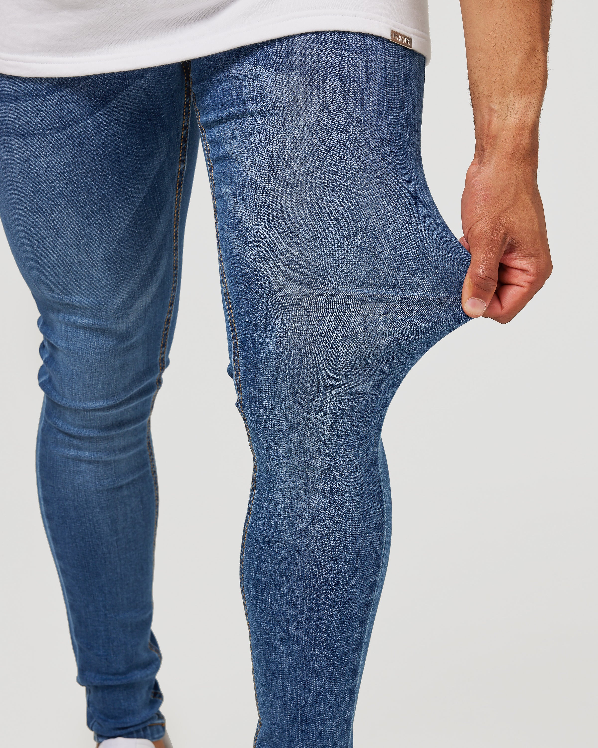 Stretching Dark Blue Jeans for men